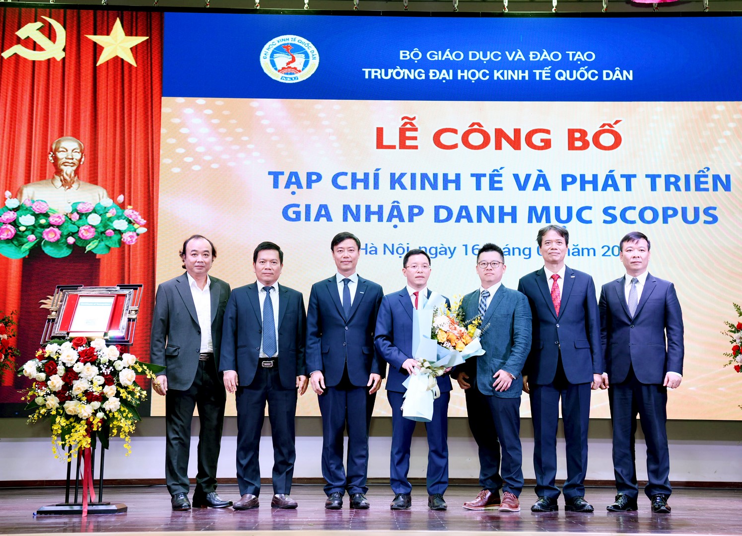 A group of men standing on a stage  Description automatically generated